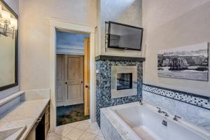 a bathroom with a tub and a tv on the wall at Oceanfront Dream Hideaway and Retreat in Gualala +68 photos