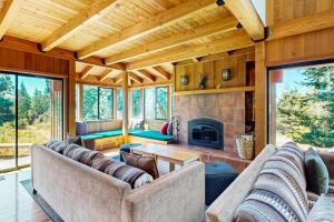 a living room with two couches and a fireplace at Ocean Pines Lodge in Sea Ranch