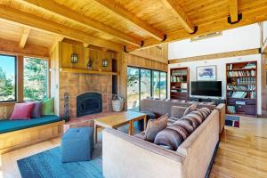 a living room with a couch and a fireplace at Ocean Pines Lodge in Sea Ranch