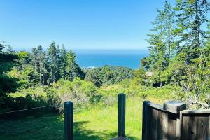 a view of the ocean from a wooden fence at Cypress Cove in Sea Ranch