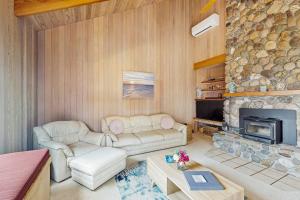 a living room with a couch and a fireplace at Cypress Cove in Sea Ranch