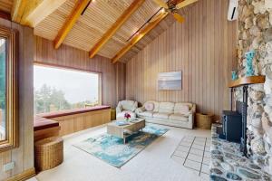 a living room with a couch and a fireplace at Cypress Cove in Sea Ranch