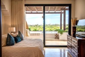 a bedroom with a bed and a view of a tub at Hacienda Todos Los Santos in Todos Santos +101 photos