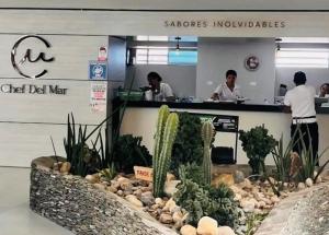 a store with people standing at a counter with plants at Reserva del Mar 539 in Santa Marta +76 photos