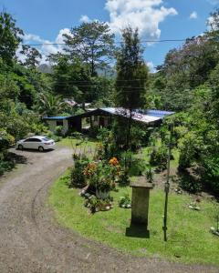 a garden in front of a house with a car at Kibutz Eco Guesthouse in Fortuna +37 photos