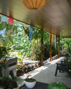 an outdoor patio with a heater and plants at Kibutz Eco Guesthouse in Fortuna