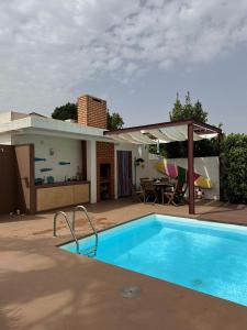 a swimming pool in the backyard of a house at Casa de Muranzel in Torreira