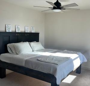 a bedroom with a bed with a ceiling fan at The Farmhouse in Darby