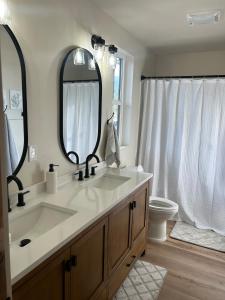 a bathroom with a sink and a mirror and a toilet at The Farmhouse in Darby