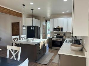 a kitchen with white cabinets and a large kitchen island at The Farmhouse in Darby +6 photos