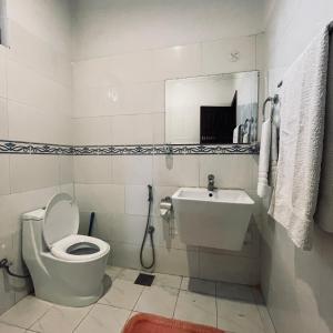 a bathroom with a toilet and a sink at Ziel Guest House Banigala Islamabad Near Gerrys & NIH Hospital in Islamabad +77 photos
