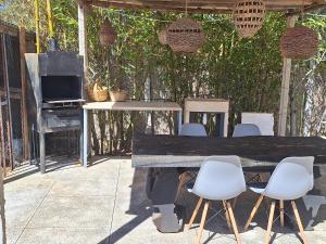 a wooden table with chairs and a tv on a patio at loft B in Fez