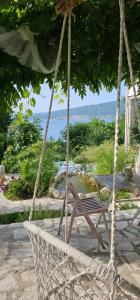 a rope swing with a bench and a table at Apartmani VERONA in Bijela