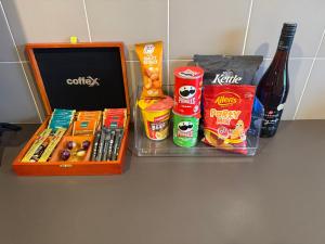 a table with a box of food and a bottle of beer at Motel Strahan in Strahan