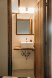 a bathroom with a sink and a mirror at El Mesón de Don José in La Mesa