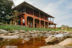 a building on a hill next to a body of water at El Mesón de Don José in La Mesa
