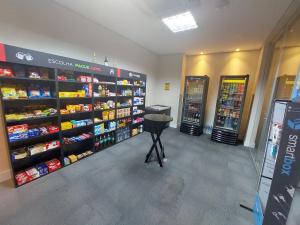 a store aisle with shelves of products in a store at Book Santos Mar, Sol e Conforto no Unique 710 e 810 in Santos +59 photos