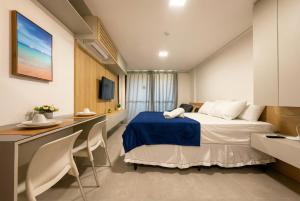 a hotel room with a bed and a desk at Beach Class Summer Residence in Porto De Galinhas +72 photos