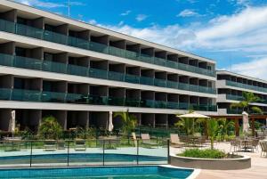an image of a hotel with a swimming pool at Beach Class Summer Residence in Porto De Galinhas
