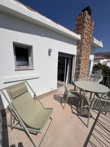 a patio with a table and chairs next to a building at Terraza Montaña in Nerja