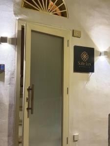 a door to a bathroom with a sign on it at SUITE LUX apulia in Massafra