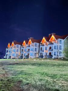 a row of large apartment buildings at night at Boynuz Hotels in Nyahururu