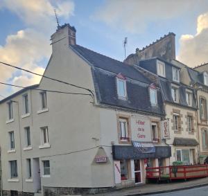 a white building on the side of a street at Hôtel de la Gare - Morlaix in Morlaix