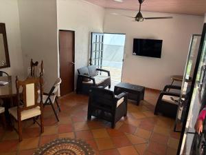 a living room with chairs and a flat screen tv at Cabaña AWA in Puerto Salgar