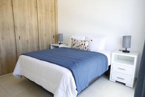 a bedroom with a bed and two night stands at Villa Labuena in Punta Cana +23 photos
