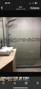 a bathroom with a shower with a sink and a mirror at Luxury House Cascais in Cascais +13 photos
