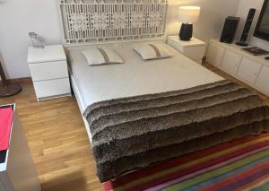 a bedroom with a large bed with two pillows at Luxury House Cascais in Cascais