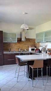 a kitchen with a large white table and chairs at La finestra sul lago in Clusane sul Lago