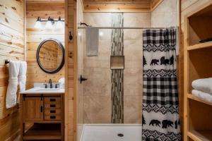 a bathroom with a shower and a sink at Firefly Cabin in Pigeon Forge +42 photos