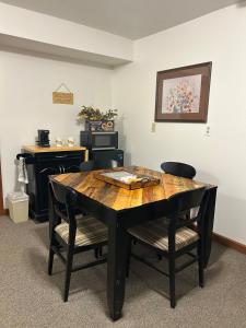 a dining room table with two chairs and a desk at Cabin Hilltop D on Meramec River in Steelville