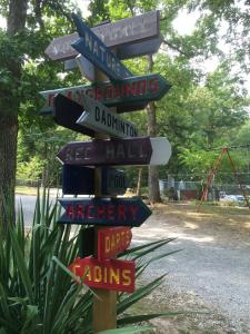 a street sign with many different signs on it at Cabin Hilltop D on Meramec River in Steelville +4 photos