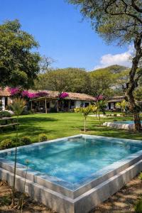 a swimming pool in the yard of a house at Hacienda San Francisco in Tumbabiro