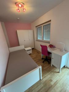 a bedroom with a bed and a desk and a desk at Entspannung am Wald in Wald-Michelbach
