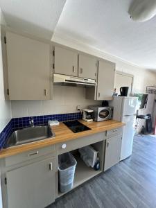 a kitchen with white cabinets and a sink at Saddle Mountain Lodge in Blue River