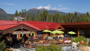 a restaurant with tables and umbrellas in front of it at Saddle Mountain Lodge in Blue River