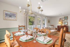 a dining room and living room with a table and chairs at Central AC Game Room Dog-Friendly in Chatham