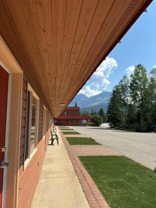 a building with a wooden roof with a sidewalk at Saddle Mountain Lodge in Blue River
