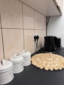 a counter with three crock pots and a table of food at Hotel Style Room within Reading in Reading