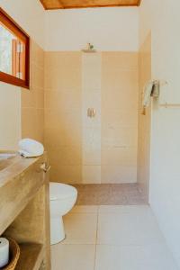 a bathroom with a toilet and a shower at Echoes Surf Casitas in Mechapa
