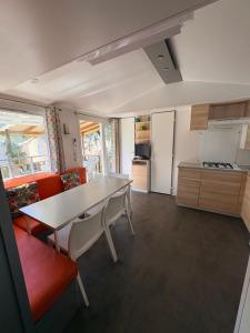 a kitchen with a table and chairs in a room at Camping la sainte baume in Nans-les-Pins