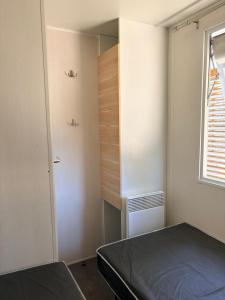 a small bedroom with a bed and a closet at Camping la sainte baume in Nans-les-Pins +48 photos