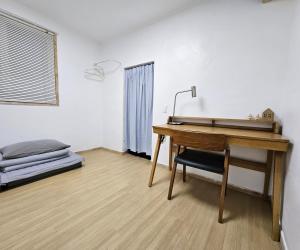a desk with a lamp and a bed in a room at 스테이 노랑 stay norang in Daegu