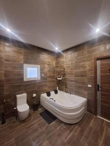 a large bathroom with a tub and a toilet at Villa Casablanca in 6th Of October +10 photos