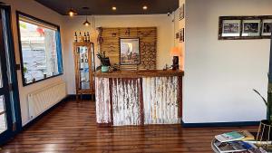 a room with a bar in the middle of a room at Pristine Patagonia Hotel in Puerto Natales +26 photos