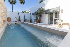 a swimming pool in front of a house at Vacança beach in Denia