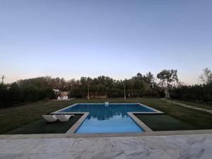 a swimming pool in the middle of a yard at Villa Casablanca in 6th Of October